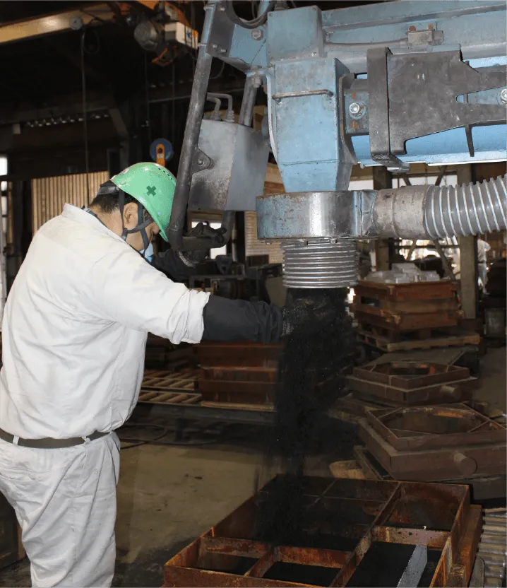金枠に砂を入れ造型作業中